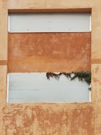 Full frame shot of weathered window on wall