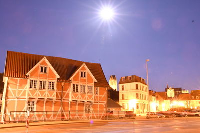 Street amidst houses and buildings against sky