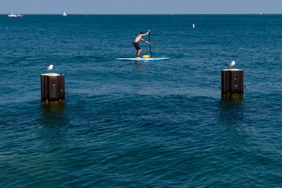 Man surf boarding on lake michigan 
