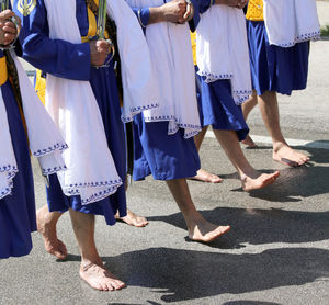 Low section of women with umbrella on street