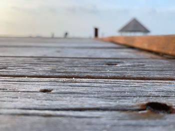 Surface level of footpath by building against sky