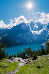 Scenic view of lake and mountains against sky on sunny day