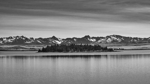 Scenic view of lake and mountains against sky