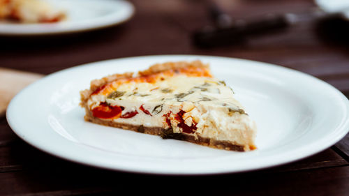 Close-up of quiche slice in plate on table