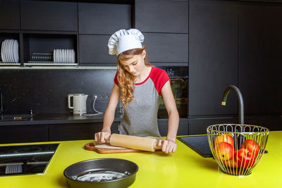 Rear view of man preparing food at home