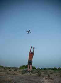 Low angle view of airplane on field against clear sky