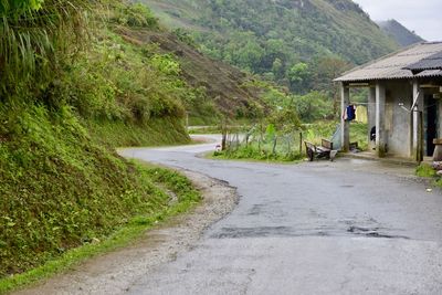Road by house against mountain
