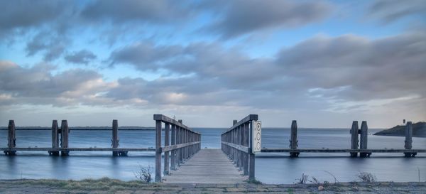 Pier over sea against sky