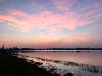 Scenic view of lake against sky during sunset