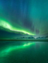 Scenic view of snowcapped mountains against sky at night