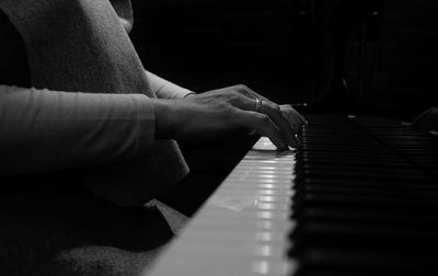 Midsection of woman playing piano