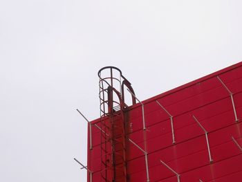 Low angle view of red light against clear sky