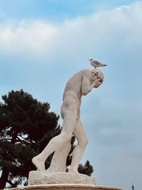 Low angle view of statue against sky