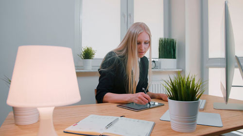 Woman using graphic tablet at table