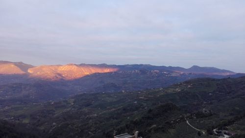 Scenic view of landscape against sky at sunset