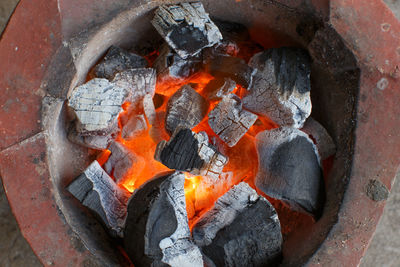 High angle view of fire on barbecue grill