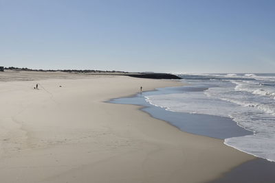 Scenic view of beach against clear sky