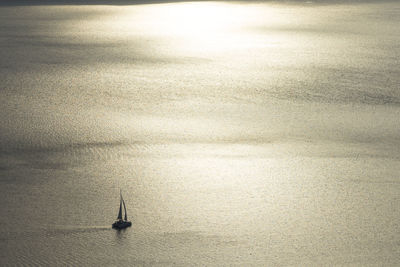 Sailboat on sea against sky
