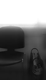 Close-up of telephone booth on table against wall