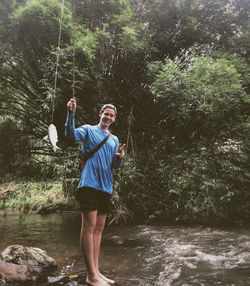 Rear view of man standing in water