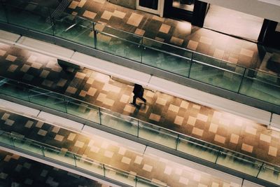 Low angle view of people on escalator at railroad station