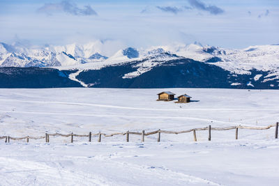 View of snow covered landscape against mountain