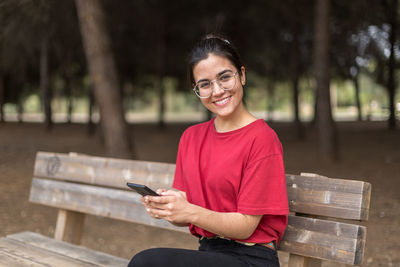 Portrait of smiling young man using mobile phone