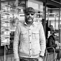 Portrait of young man standing at store