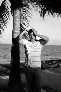 Full length portrait of man standing on beach