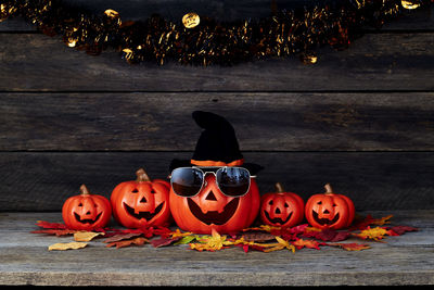 View of pumpkins against wooden wall during halloween