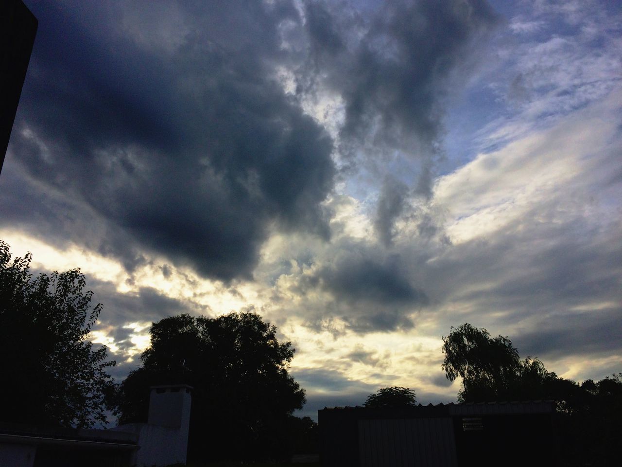 sky, low angle view, tree, cloud - sky, silhouette, cloudy, built structure, building exterior, architecture, cloud, nature, high section, beauty in nature, house, overcast, outdoors, weather, tranquility, scenics, no people