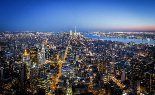 Aerial view of illuminated city at dusk