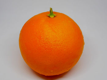 Close-up of orange apple against white background