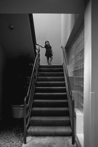 Low angle view of woman walking on steps