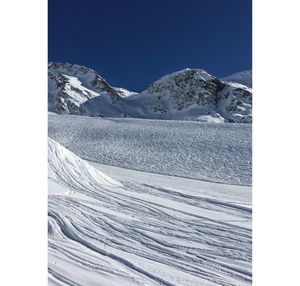 Scenic view of snowcapped mountains against clear sky