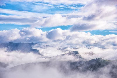 Scenic view of clouds over mountains against sky