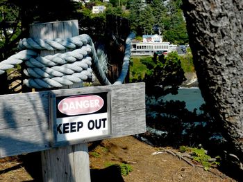 Close-up of information sign against trees