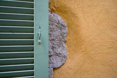 Close-up of window shutter against wall