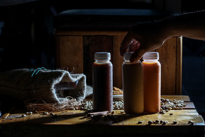 Midsection of man holding coffee beans on table