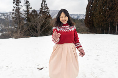 Woman standing on snow covered land