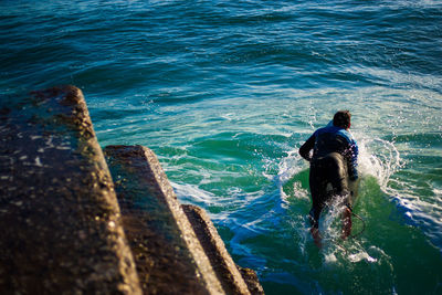 High angle view of man surfing on sea