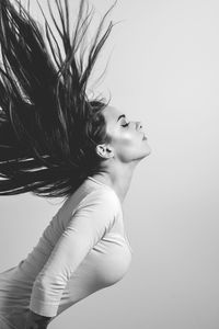 Portrait of woman looking away over white background