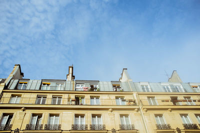 Low angle view of building against cloudy sky