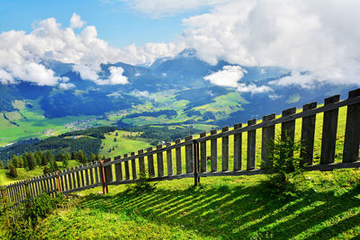 Scenic view of field and mountains against sky