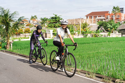 Man riding bicycle on field