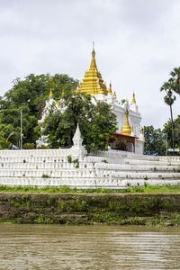 Close-up of a limestone pagoda against cloud-sky