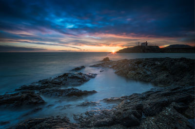 Scenic view of sea against sky during sunset