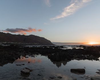 Scenic view of sea and mountains during sunset