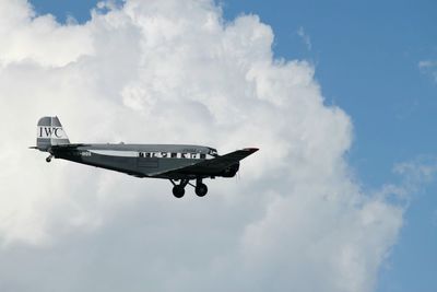 Low angle view of airplane flying against sky