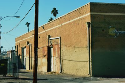 Exterior of warehouse against clear blue sky